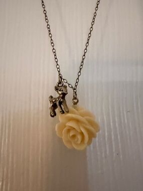 Cute charm necklace with a fawn and a flower. 
Great condition.